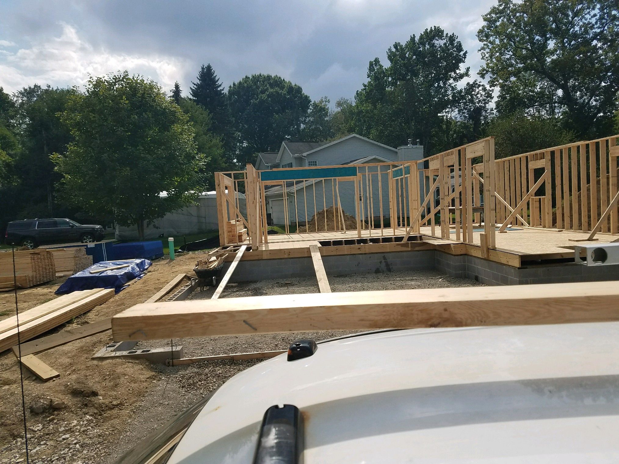 Floor deck on the foundation with the first wall frames standing.