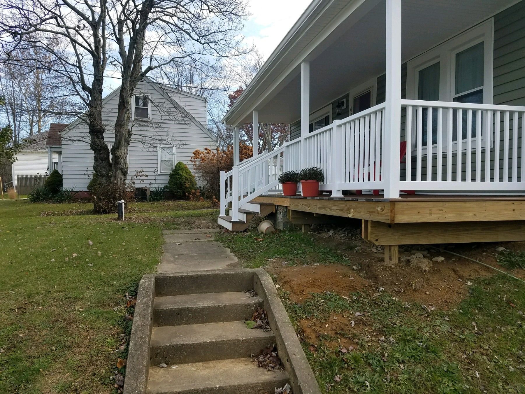 Side view of the new porch deck and railing from the walkway.