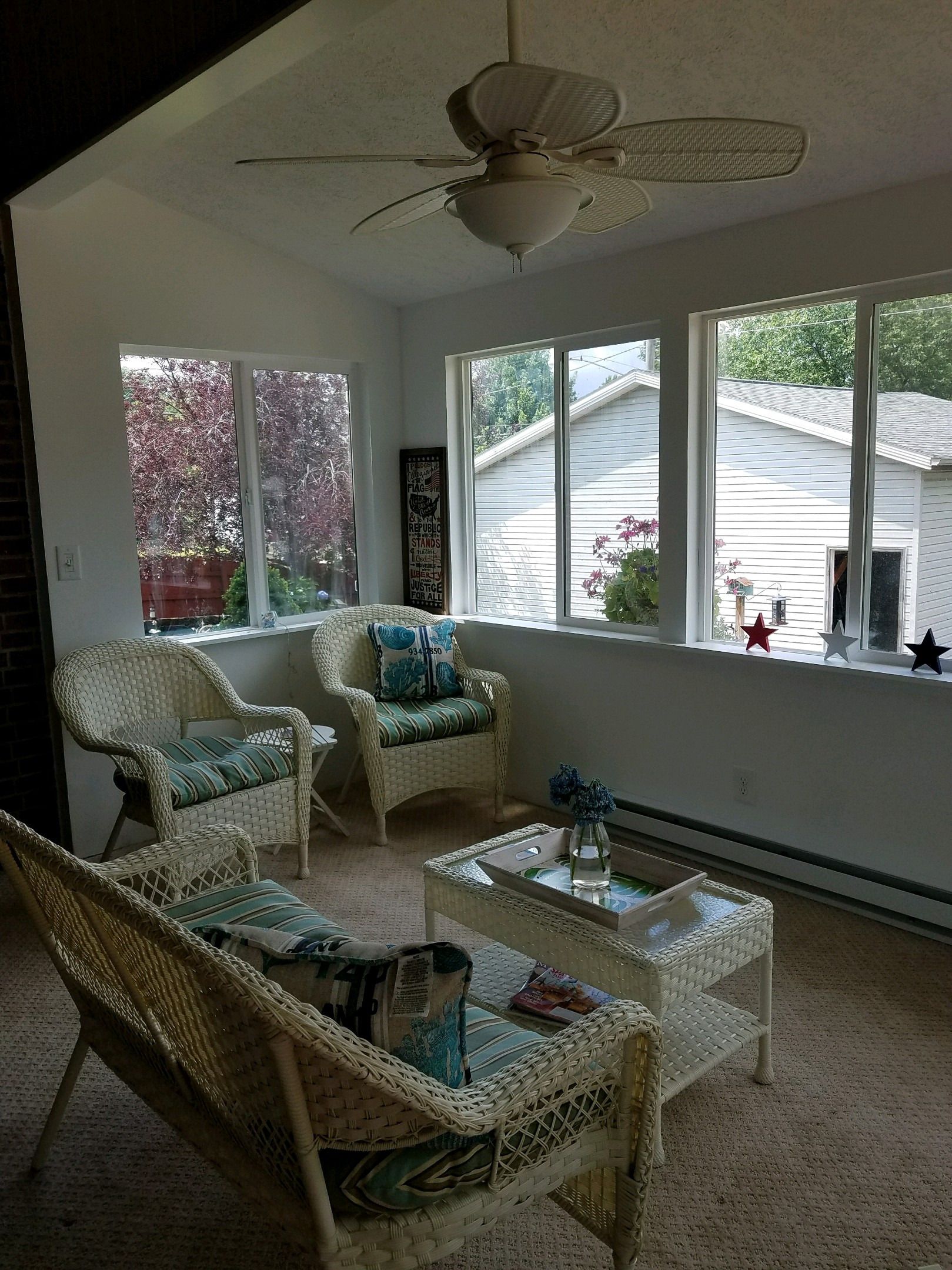 Finished sunroom interior with seating and natural light from the windows.